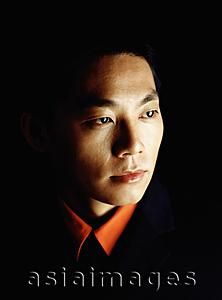 Asia Images Group - Male executive looking away, portrait, black background