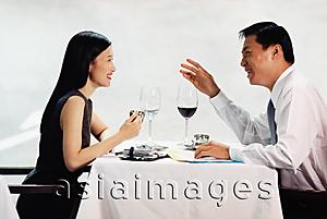 Asia Images Group - Male and female executives talking in restaurant