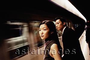 Asia Images Group - Couple walking, woman holding man's arm, smiling at each other