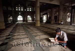 Asia Images Group - Singapore, Arab Street, Muslim man reads Koran in Mosque.