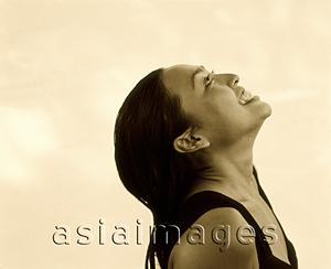 Asia Images Group - Woman looking upwards, profile, white background