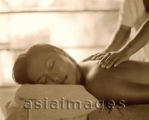 Asia Images Group - Woman with eyes closed getting a massage