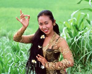 Asia Images Group - Indonesia, Bali, Balinese dancer in traditional costume, portrait in field