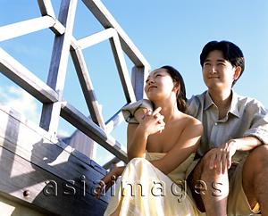 Asia Images Group - Man sitting with arm around woman