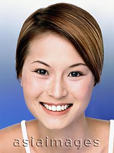 Asia Images Group - Young woman smiling, blue background, portrait