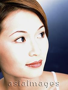Asia Images Group - Young woman, blue background, portrait