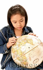 Asia Images Group - Young girl looking at globe.