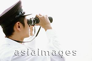 Asia Images Group - Profile of man in white looking through binoculars, white background