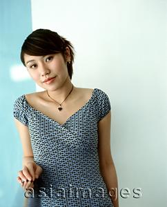 Asia Images Group - Young woman leaning against railing, portrait.