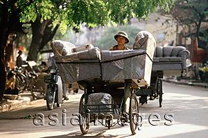 Asia Images Group - Vietnam, Hanoi, man delivering armchairs on cyclo