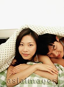 Asia Images Group - Man and woman under covers, portrait