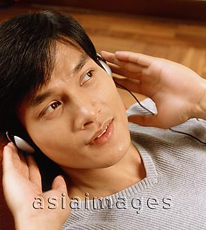 Asia Images Group - Man listening to headphones