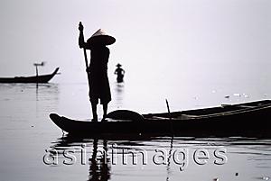 Asia Images Group - Cambodia, Ton Le Sap River, A fisherman poles along the water