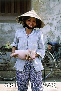 Asia Images Group - Vietnam, girl with pig at market
