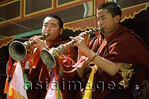 Asia Images Group - China, Szechuan (Sichuan), Kham region, Tibetan monks blowing horns.