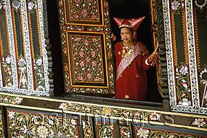 Asia Images Group - Indonesia, Sumatra West, girl in traditional Minangkabau dress in traditional house