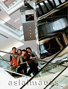 Asia Images Group - Group of friends on escalator.