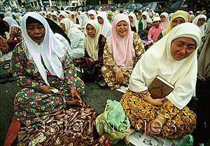Asia Images Group - Malaysia, Kota Bharu, overflow crowd of women listen to a sermon on a dusty street outside a local mosque.