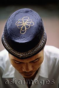 Asia Images Group - Indonesia, Jakarta, Worshipper wears an embroidered prayer cap, called a songkok or kopiah, at Istiqlal Mosque.