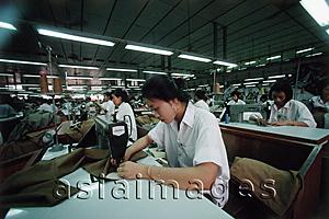 Asia Images Group - Vietnam, Ho Chi Minh City, Women sewing fabric in a factory.