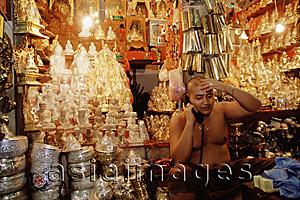 Asia Images Group - Myanmar (Burma), Yangon (Rangoon), Monk tending shop at the Shwedagon Pagoda.