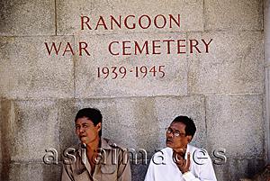 Asia Images Group - Myanmar (Burma), Yangon (Rangoon), Men sitting by one of the signs in Rangoon War Cemetery.