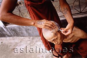 Asia Images Group - Myanmar (Burma), Yangon (Rangoon), One monk helping another shave his head.
