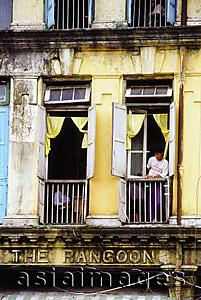 Asia Images Group - Myanmar (Burma), Yangon (Rangoon), A man looking out of a window in an old colonial building.