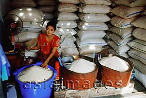 Asia Images Group - Myanmar (Burma), Yangon (Rangoon), A Burmese woman selling rice of varying grades of quality in a market in Yangon.