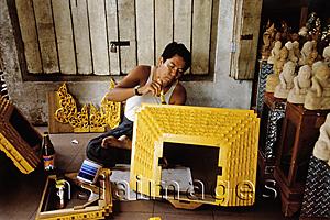 Asia Images Group - Myanmar (Burma), Yangon (Rangoon), A Craftsman putting finishing touches on a souvenir for sale at one of hundreds of shops outside of the Shwedagon Pagoda.
