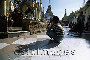 Asia Images Group - Myanmar (Burma), Yangon (Rangoon), Worshipper praying at Shwedagon Pagoda