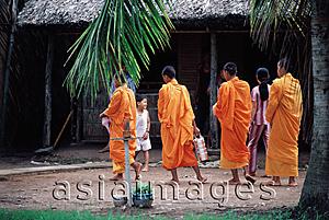 Asia Images Group - Vietnam, Mekong Delta region, Bac Lieu, Buddhist monks walking on street in search of alms.