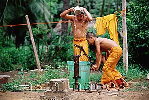 Asia Images Group - Vietnam, Mekong Delta region, Bac Lieu, Buddhist monks bathing at water pump.