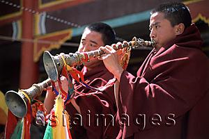 Asia Images Group - China, Szechuan (Sichuan), Kham region, Monks playing horns during monastery festival.