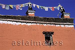 Asia Images Group - Nepal, Mustang, Young monks waving out a window of monastery.