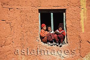 Asia Images Group - Nepal, Lo Manthang, Young monks sit on window sill and study for exams