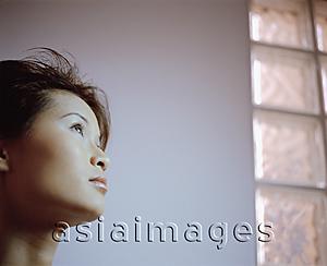 Asia Images Group - Profile of young woman looking up.