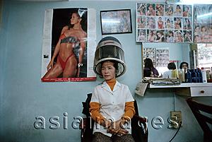 Asia Images Group - Vietnam, Hanoi, woman sitting underneath hair dryer