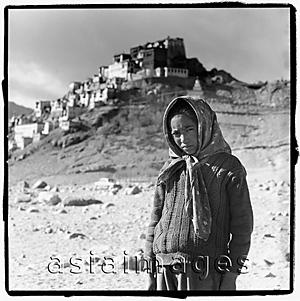 Asia Images Group - India, Ladakh, Portrait of young girl, monastery at background.