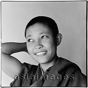 Asia Images Group - India, near Dharamsala, Dolma Ling Nunnery, Portrait of Tibetan nun smiling.