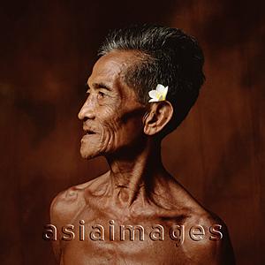 Asia Images Group - Indonesia, Bali, Ubud, Mature Balinese man with Frangipani flower adornment.