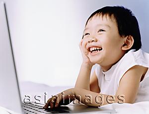 Asia Images Group - Boy, 3 years old, using laptop, smiling.