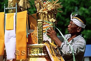 Asia Images Group - Indonesia, Bali, Gianyar, Pengastian ceremony, men decorating ceremonial tower. (grainy)