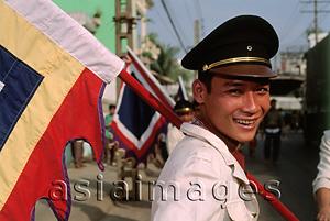 Asia Images Group - Vietnam, Ho Chi Minh City, Flag carrier at funeral procession. (grainy)