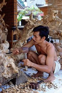 Asia Images Group - Indonesia, Bali, Ubud, Woodcarver at work. (grainy)