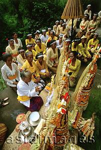 Asia Images Group - Indonesia, Bali, Gianyar, Pengastian ceremony, priestess leads prayers at holy water collection place. (grainy)