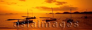 Asia Images Group - Indonesia, Flores, Labuanbajo, Sunset across beach, fishing boats in foreground. (grainy)