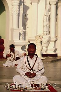 Asia Images Group - Myanmar (Burma), Yangon, Ascetic man stares into sun whilst meditating at Shwedagon Paya.