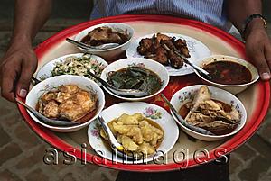 Asia Images Group - Myanmar (Burma), New Bagan, Selection of Burmese food on tray held by waiter.