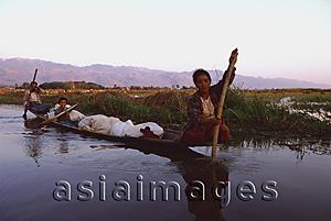 Asia Images Group - Myanmar (Burma), Inle lake, Women steering their laden canoe through backwaters.